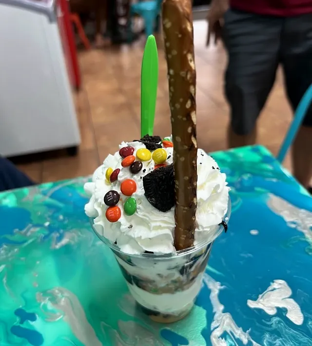A sundae on a blue and teal resin table